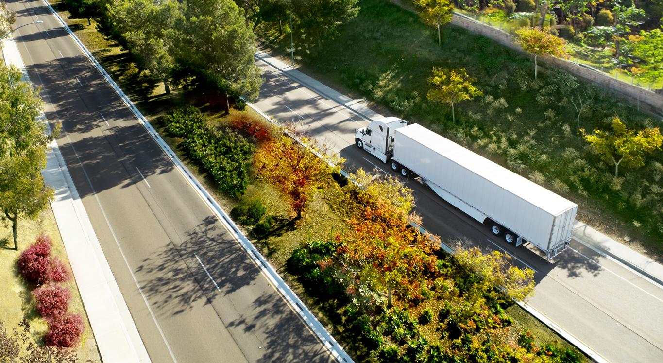NewHP2_4_14 An aerial shot of a white Hyundai Translead trailer on a highway, symbolizing advanced trailer technology and innovations in freight transport.