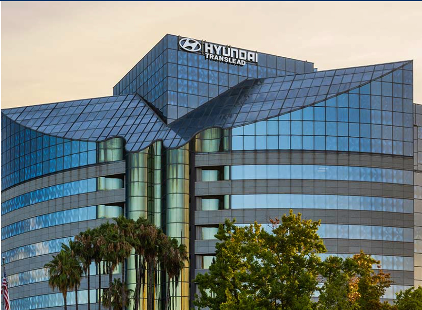 image001 Hyundai Translead headquarters building sign at dusk.