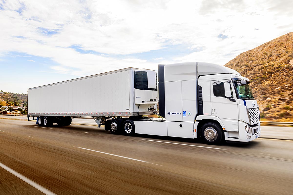 ThermoTech Hyundai Translead truck travels through mountain landscape.